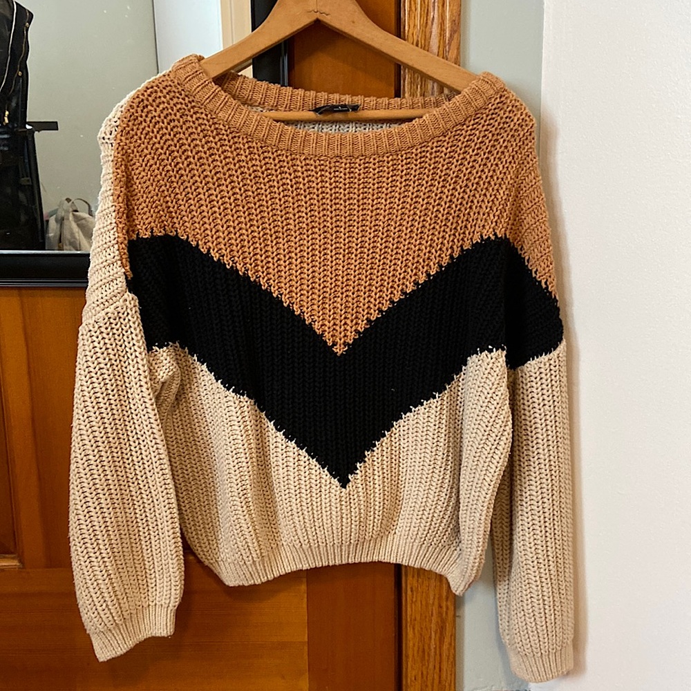 This is a super cute sweater from Lumiére. It is cream, light brown, and black!
